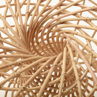 Natural woven rattan basket with a spiral pattern and light beige tones, showcasing a unique texture and design.