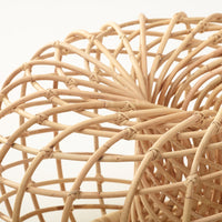 Natural woven rattan in a spiral design with beige tones and intricate interlacing patterns.