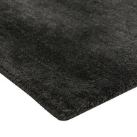 Soft black area rug with a textured, shaggy finish, perfect for modern decor.