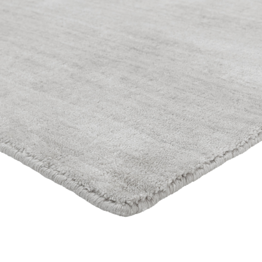 Soft, textured light gray area rug with a subtle pattern, perfect for modern interiors.
