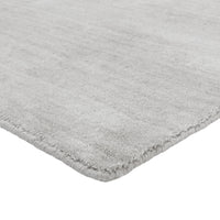 Soft, textured light gray area rug with a subtle pattern, perfect for modern interiors.