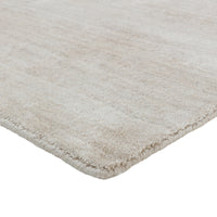 Soft beige rug with a subtle textured pattern, perfect for adding warmth to any space.