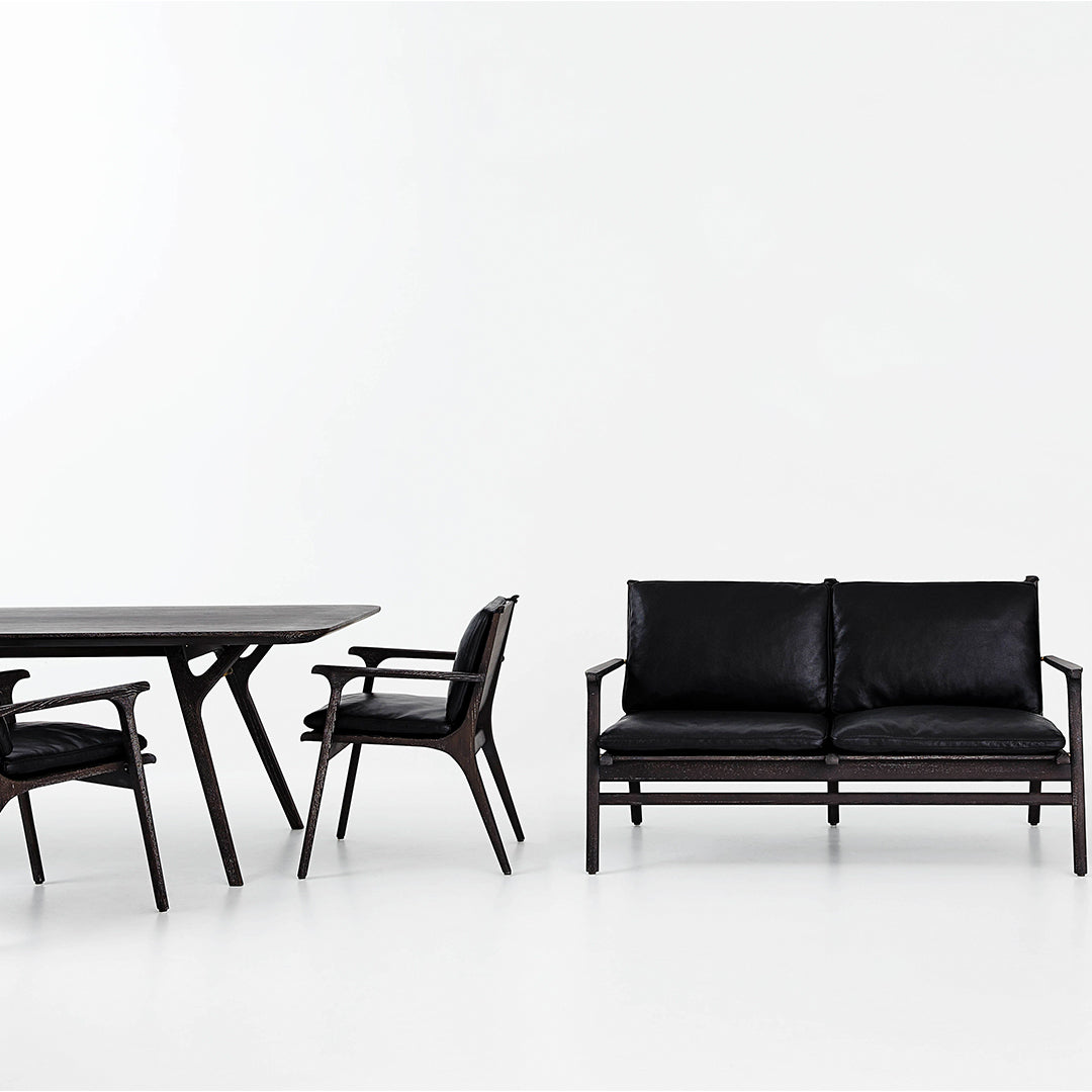 Sleek black furniture set featuring smooth leather upholstery and stylish wooden frames, perfect for modern decor.