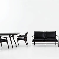 Sleek black furniture set featuring smooth leather upholstery and stylish wooden frames, perfect for modern decor.