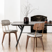 Stylish black dining table with gray and wooden chairs, featuring a modern minimalist design and neutral color palette.
