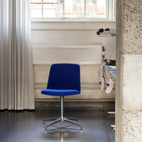 Vibrant blue chair with a sleek, modern design and a minimalist pattern. Perfect for contemporary decor.
