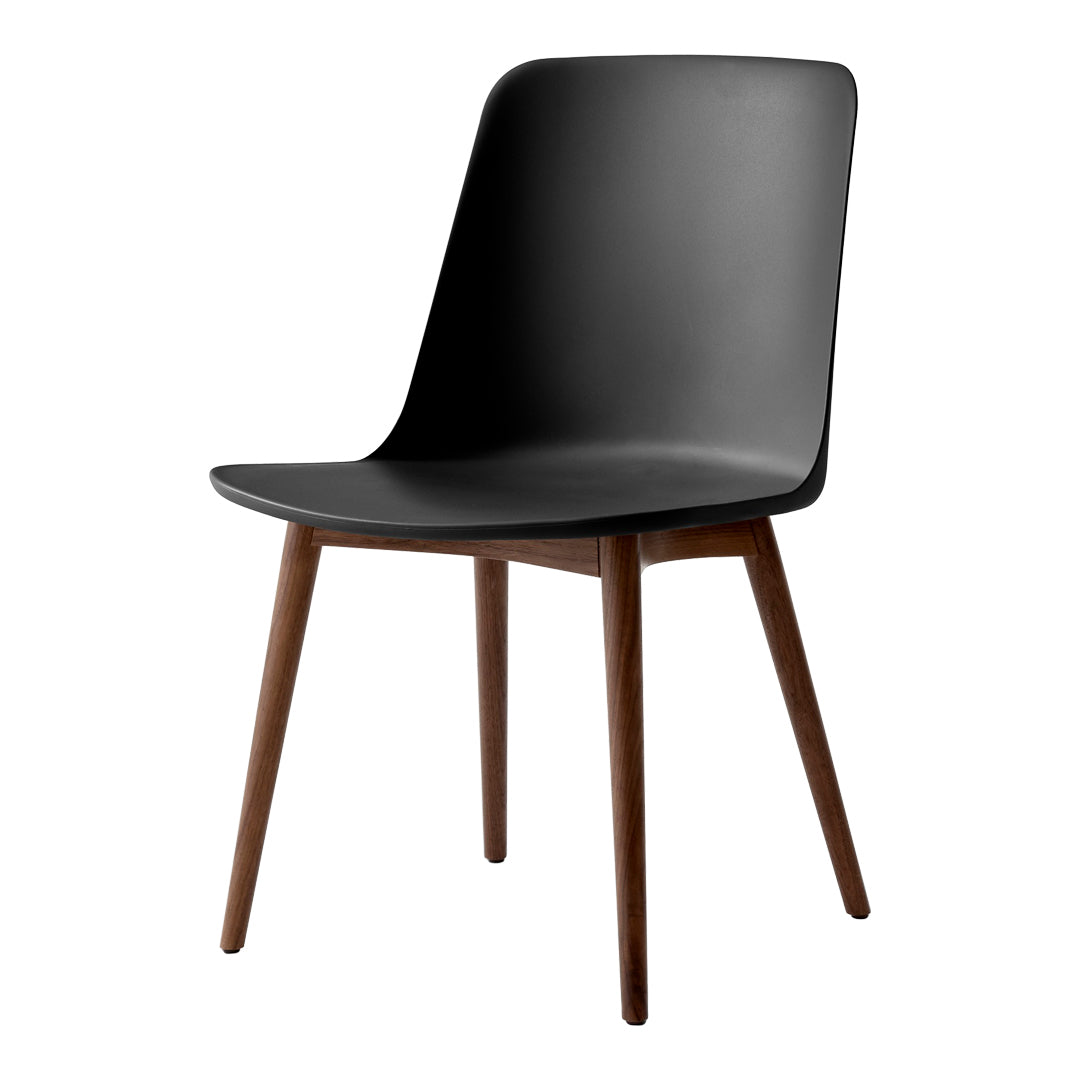"Modern black chair with smooth finish and wooden legs, featuring minimalist design and sleek silhouette."