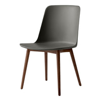 Gray plastic chair with a smooth finish and wooden legs, showcasing a minimalist design and modern aesthetic.