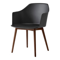 Black plastic armchair with wooden legs, featuring a sleek, modern design and smooth finish. Perfect for contemporary spaces.
