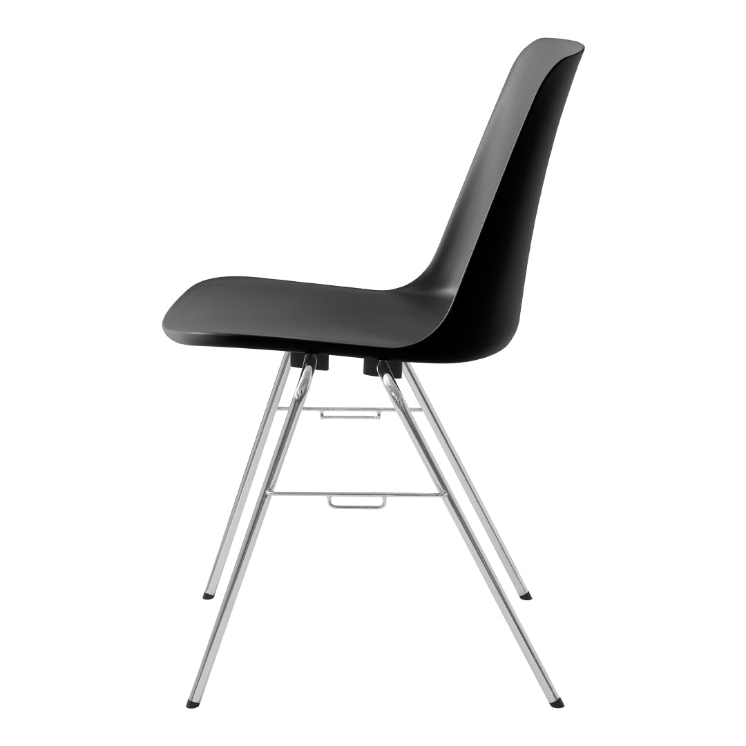 Black molded chair with sleek silver legs, featuring a minimalist design and smooth, glossy finish.