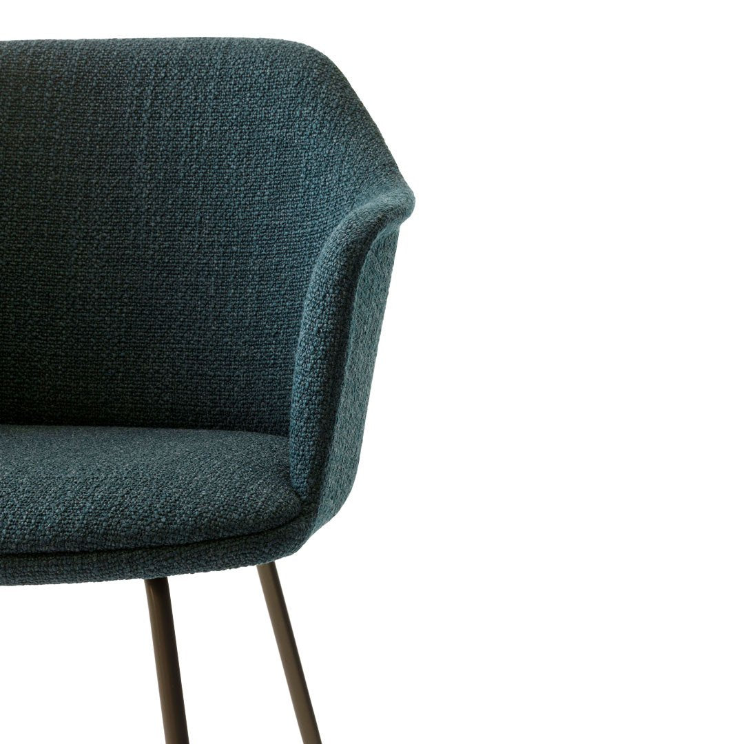 Teal textured chair featuring a modern design with sleek black metal legs. Perfect for stylish home decor.