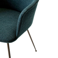 Teal upholstered chair with a textured pattern and sleek metal legs. Ideal for modern decor.