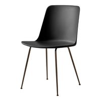 Black modern chair with smooth finish and sleek, minimalist design, complemented by metallic tapered legs.