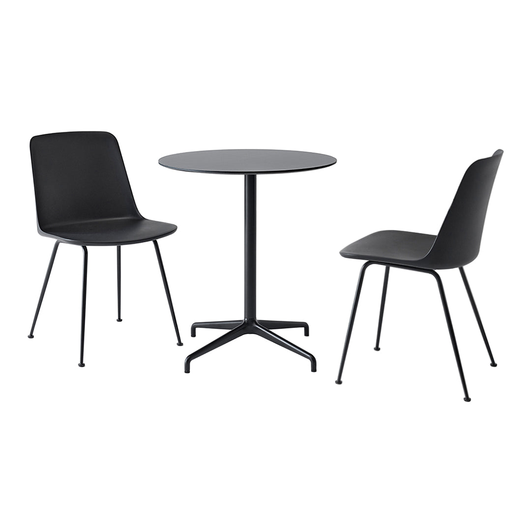 Black dining table and chairs with sleek, modern design. Smooth surfaces and minimalist style create a chic look.