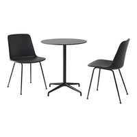 Black dining table and chairs with sleek, modern design. Smooth surfaces and minimalist style create a chic look.