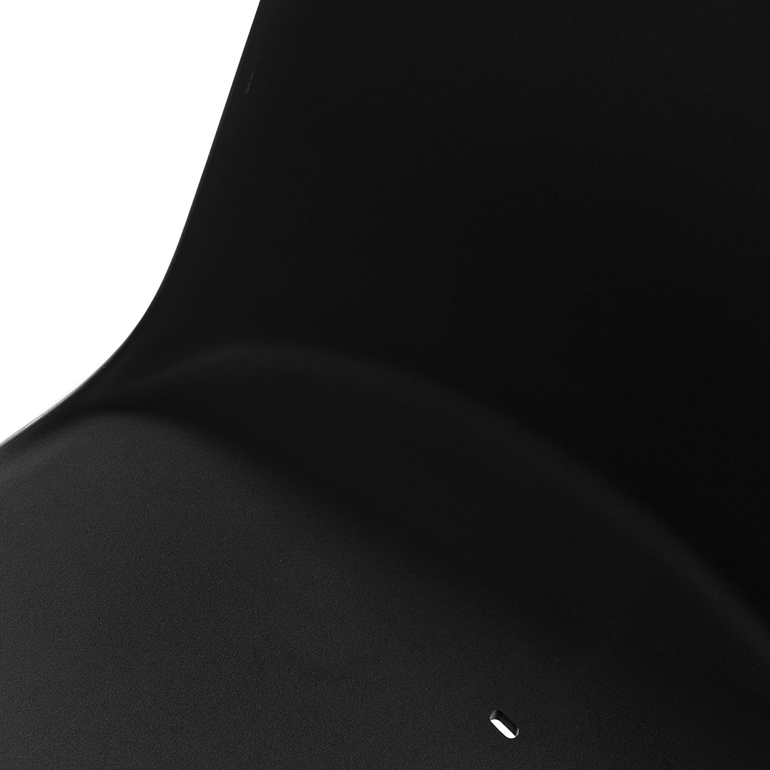 Sleek matte black chair with smooth curves and subtle shine, offering a modern minimalist aesthetic.