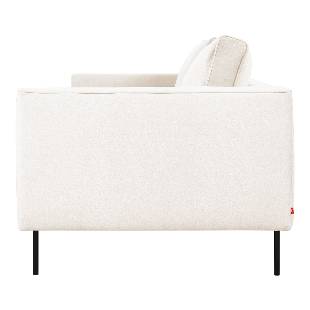 Cream-colored sofa with a smooth, textured fabric, featuring sleek black metal legs. Modern and minimalist design.