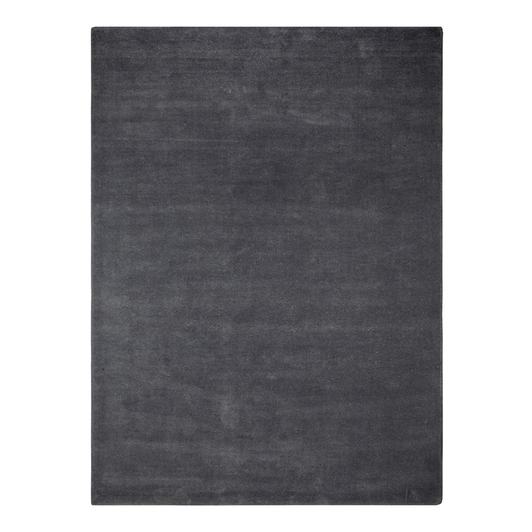 Solid charcoal gray area rug with a smooth, textured surface, perfect for modern decor.