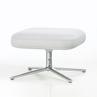 Modern white ottoman with a smooth leather texture and sleek chrome base, perfect for minimalist decor.