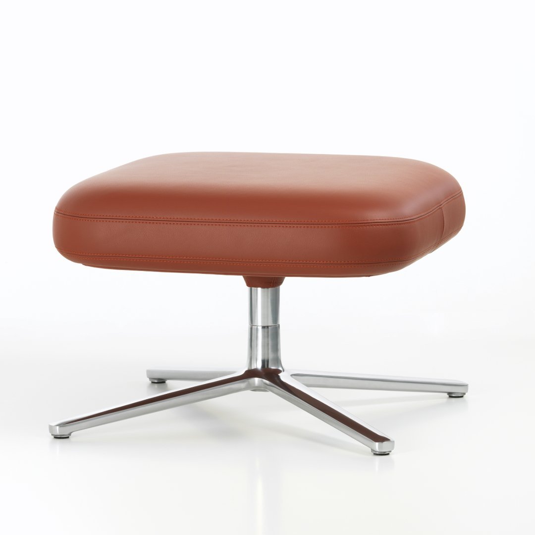 Brown leather square ottoman with a sleek chrome base and minimalist design. Perfect for modern decor.