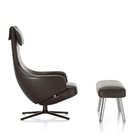 Modern black leather armchair with sleek lines and a matching ottoman in a minimalist design.