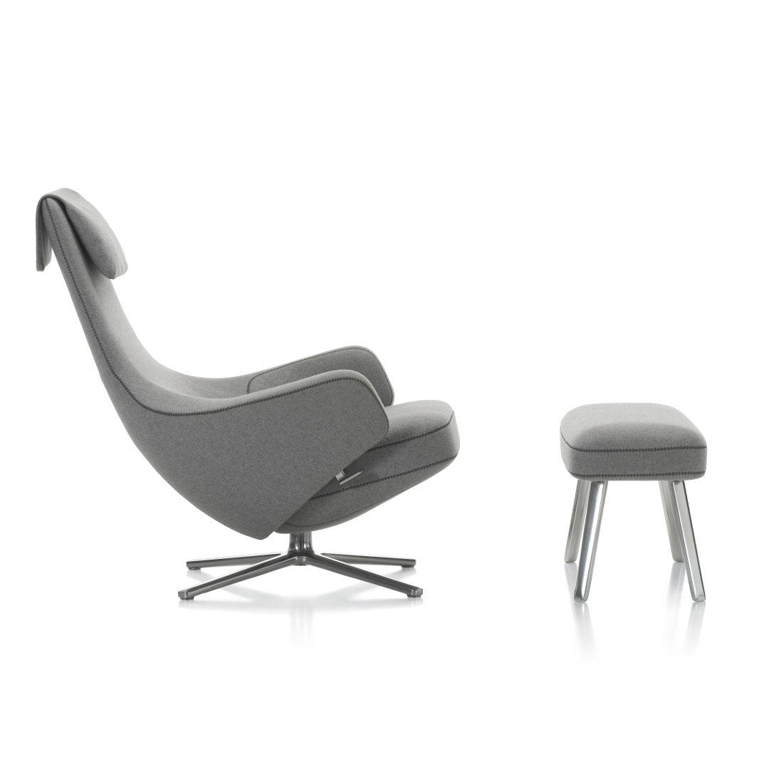 Gray upholstered lounge chair with matching ottoman, featuring a sleek design and minimalist patterns.