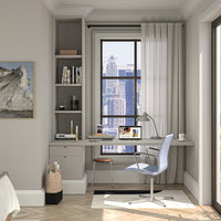 Modern home office with a gray desk, white curtains, and a light blue chair, accented by warm wooden tones and neutral walls.