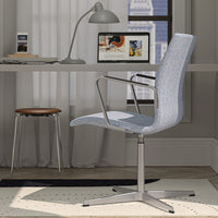 Light blue patterned office chair with silver accents, set against a neutral backdrop and soft rug.
