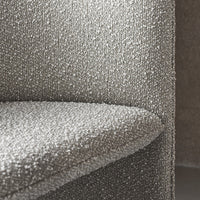 Textured light gray fabric with a subtle speckled pattern covering a modern piece of furniture.