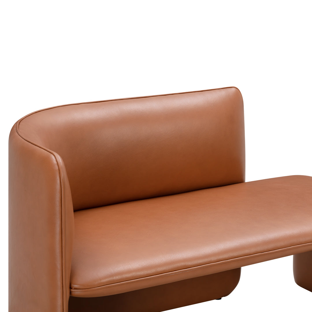 Tan leather sofa with a sleek, minimalist design and smooth, curved edges. Perfect for modern interiors.