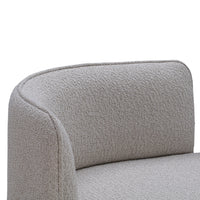 Light gray upholstered armchair with a textured, subtle patterned fabric. Ideal for modern and minimalist decor.