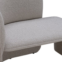 Light beige textured fabric upholstery on a modern lounge chair with a minimalist design.