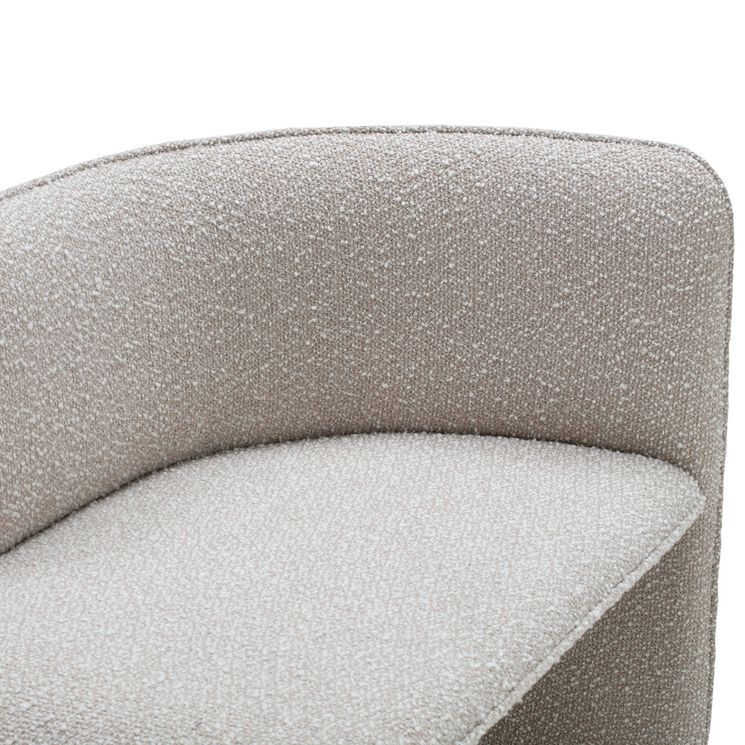 Textured beige upholstery with a subtle, soft pattern on a modern, curved chair design.