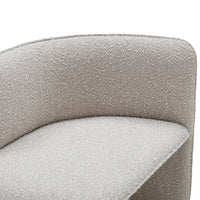 Textured beige upholstery with a subtle, soft pattern on a modern, curved chair design.