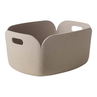 Beige storage basket with a textured finish and cut-out handles, featuring a modern design. Ideal for organization.