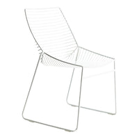 White wire chair with sleek lines and a minimalistic design, perfect for modern decor.