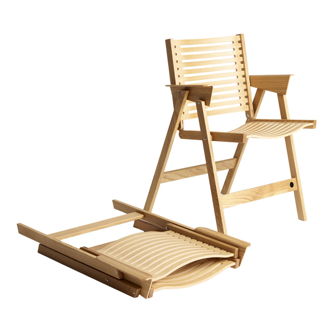 Light wooden folding chair with natural slatted design and matching footrest, showcasing a minimalist aesthetic.
