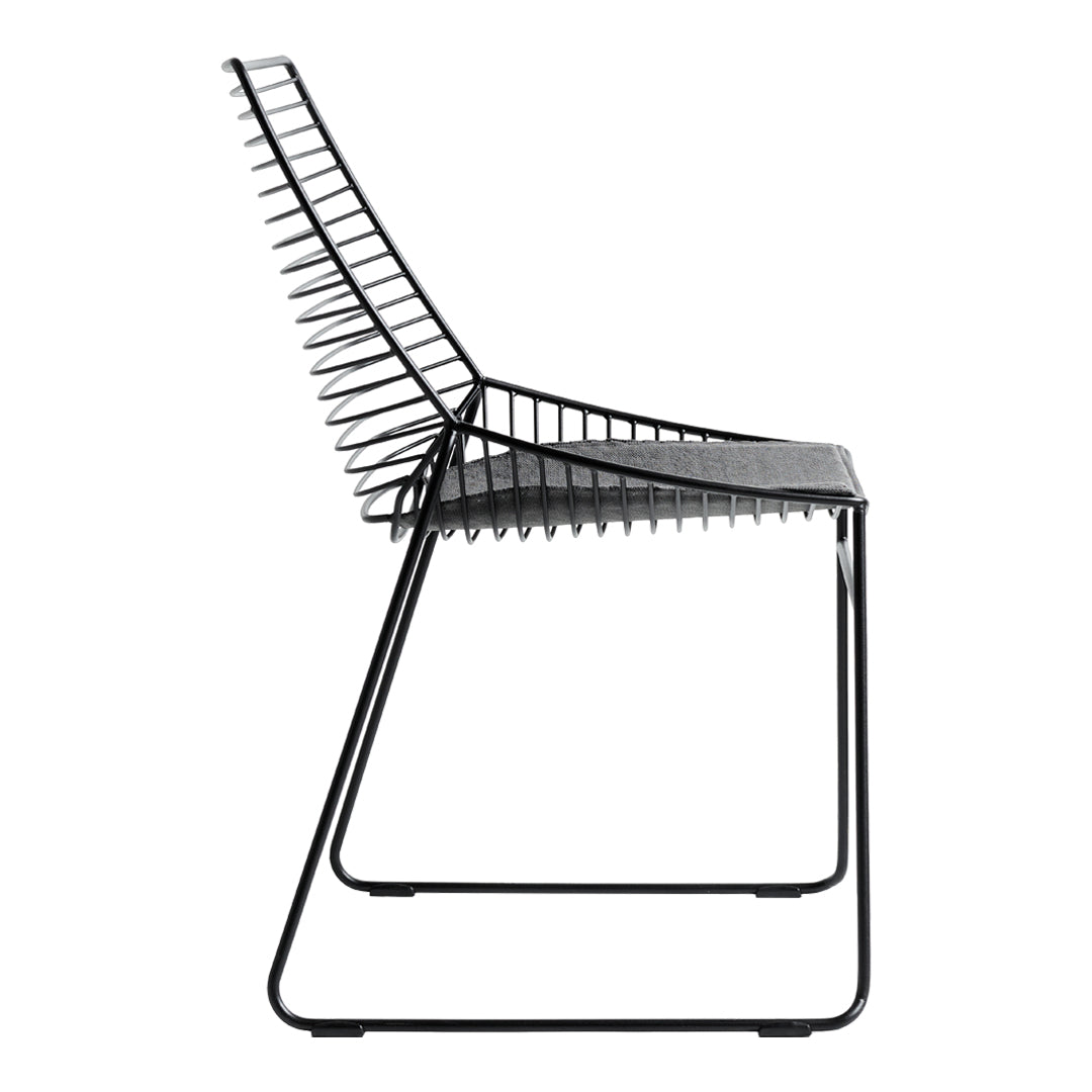 Black chair with a sleek, geometric design featuring vertical slats and a minimalist frame.