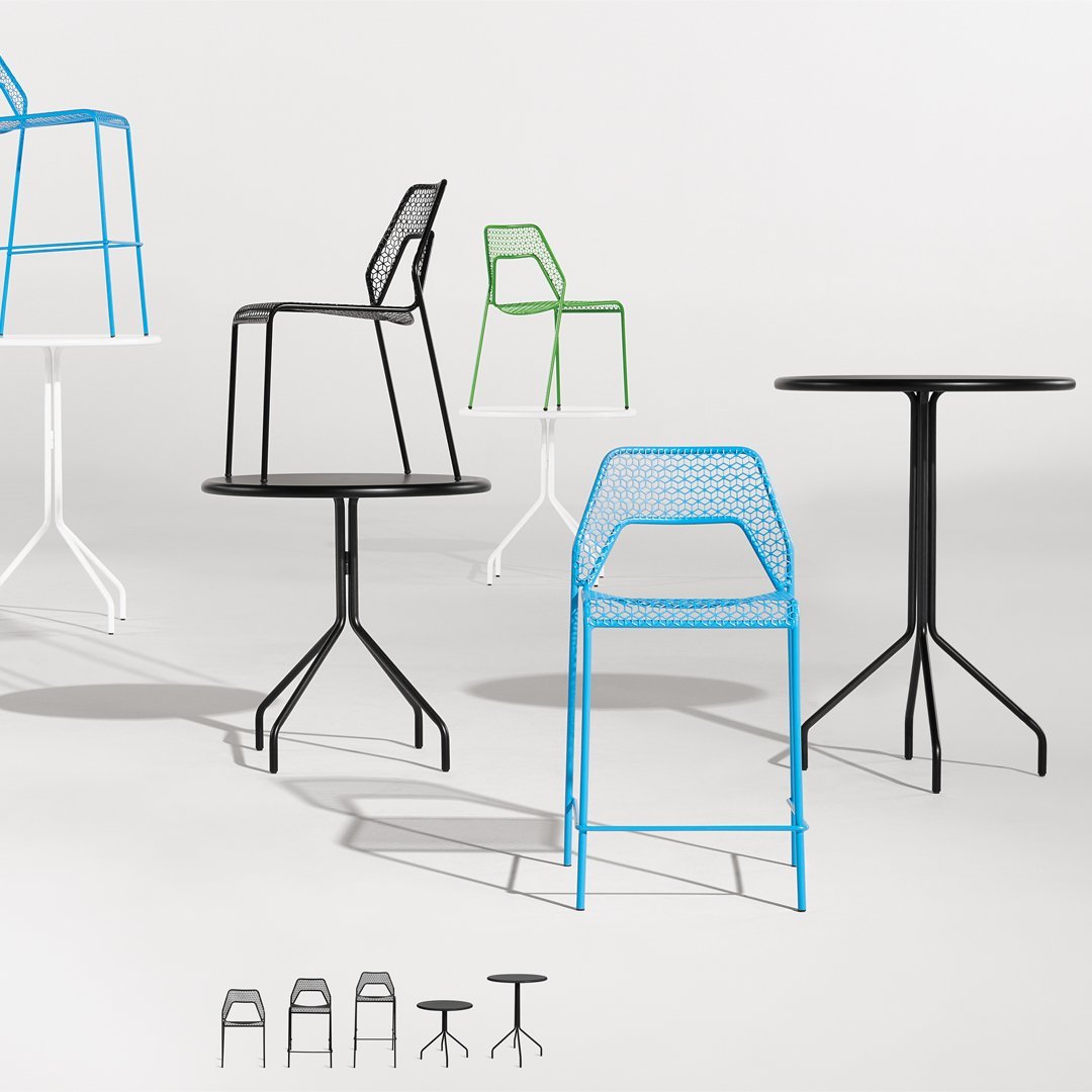 Colorful metal chairs and tables featuring a variety of patterns in black, white, green, and blue.