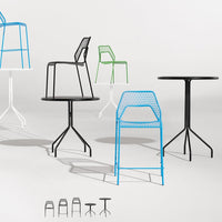 Colorful metal chairs and tables featuring a variety of patterns in black, white, green, and blue.