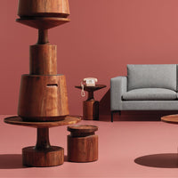 Stylish wooden furniture in warm brown tones against a muted pink background, featuring modern shapes and clean lines.