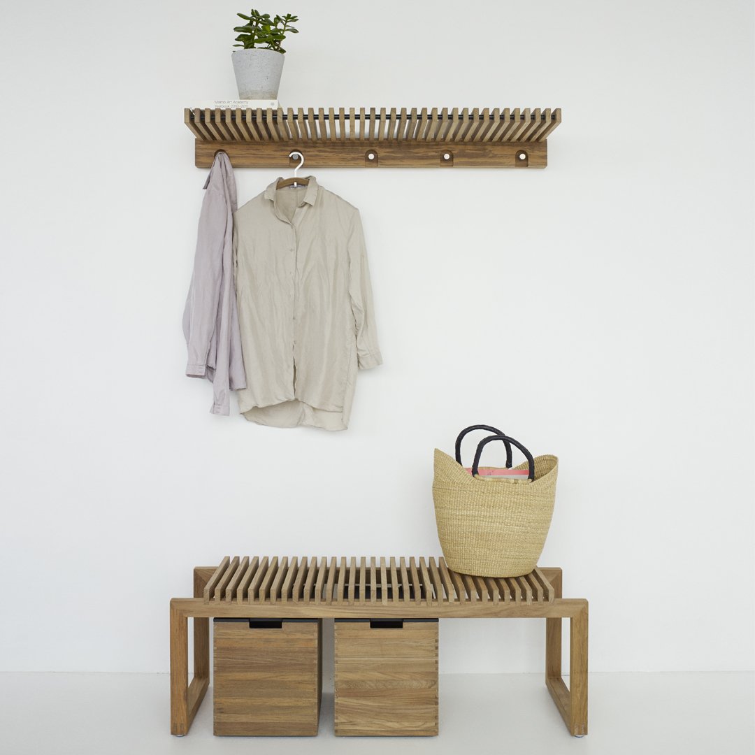Light wooden bench and wall shelf with natural tones; beige top, slatted design, and wicker basket accent.