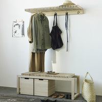 Wooden coat rack and bench with a natural finish, featuring earthy tones and minimalistic patterns.