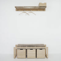 Light wood shoe rack and wall-mounted coat hanger with a slatted design and three storage boxes in a minimalist style.