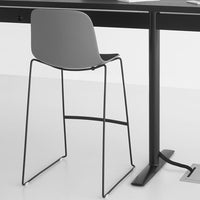 Gray modern stool with a sleek black metal frame, featuring a minimalist design and smooth surface. Perfect for contemporary spaces.