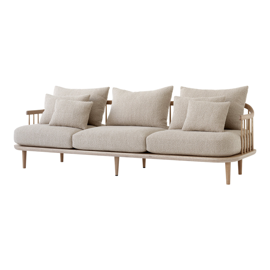 Beige sofa with textured fabric and multiple soft cushions, featuring a minimalist design and natural wood legs.