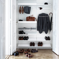 Sleek white shelves with black shoes, grey clothing, and brown accessories in a stylish closet organization setup.