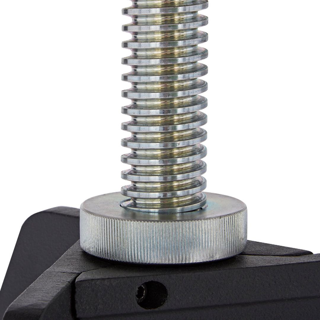 Close-up of shiny metallic thread with a circular silver plate on a black base.