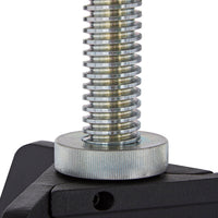 Close-up of shiny metallic thread with a circular silver plate on a black base.
