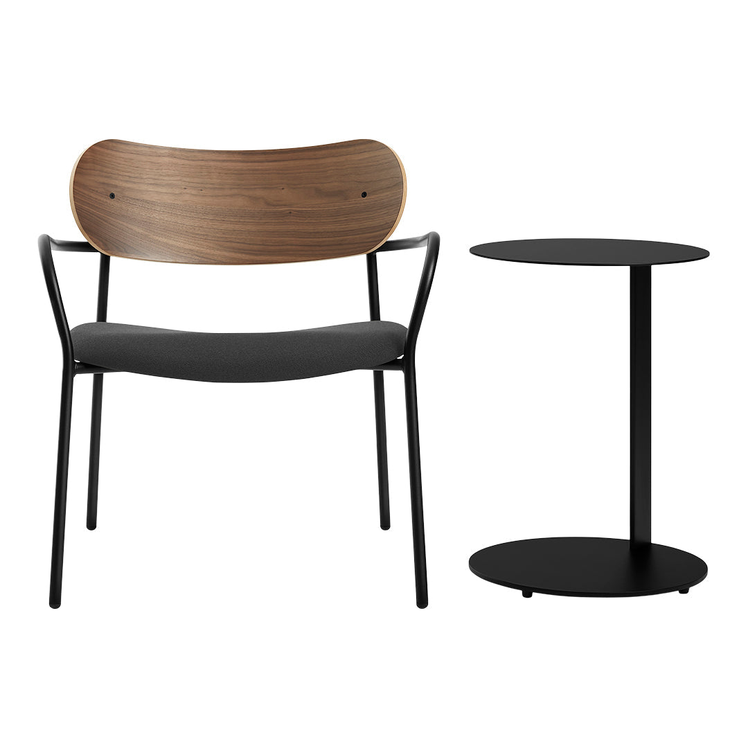 Black metal chair with a curved wooden backrest and simple round black side table. Modern, minimalist design, neutral tones.